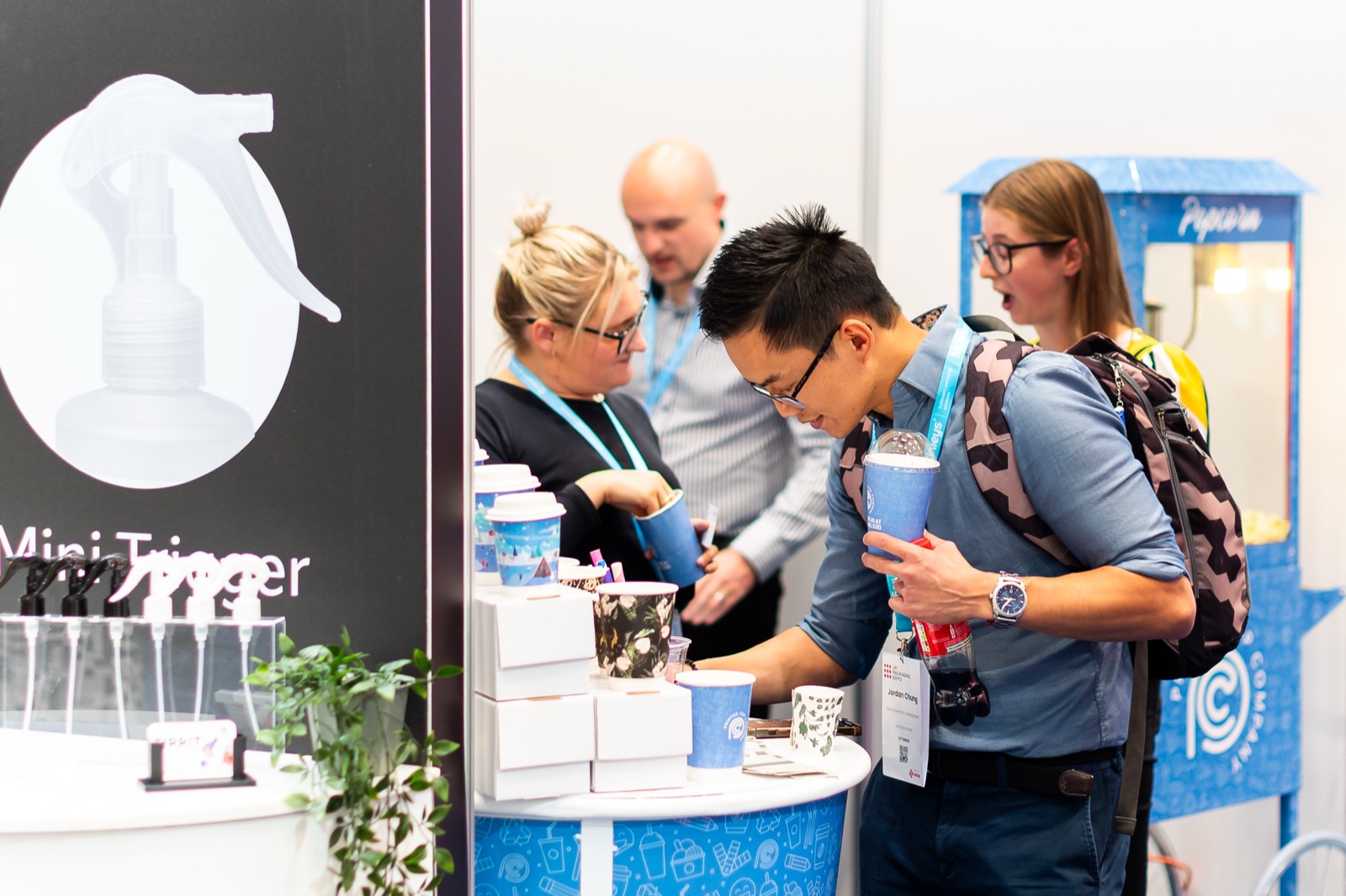 Packaging buyers reviewing product samples with an exhibitor
